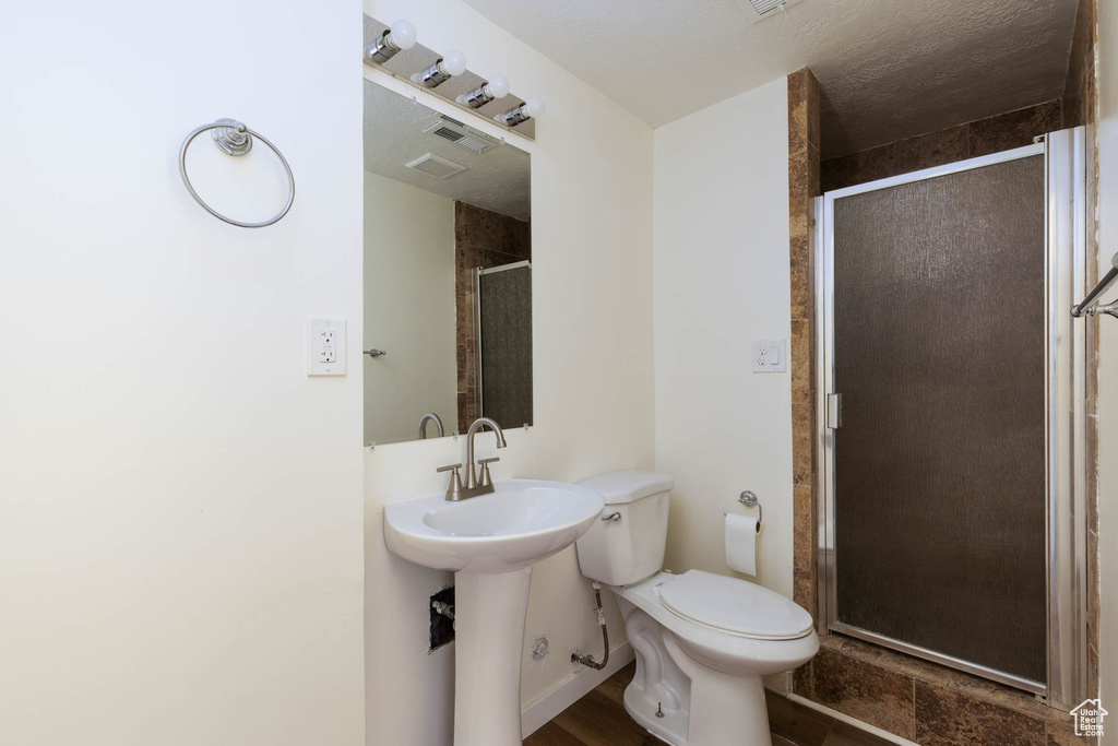 Bathroom with a stall shower and toilet