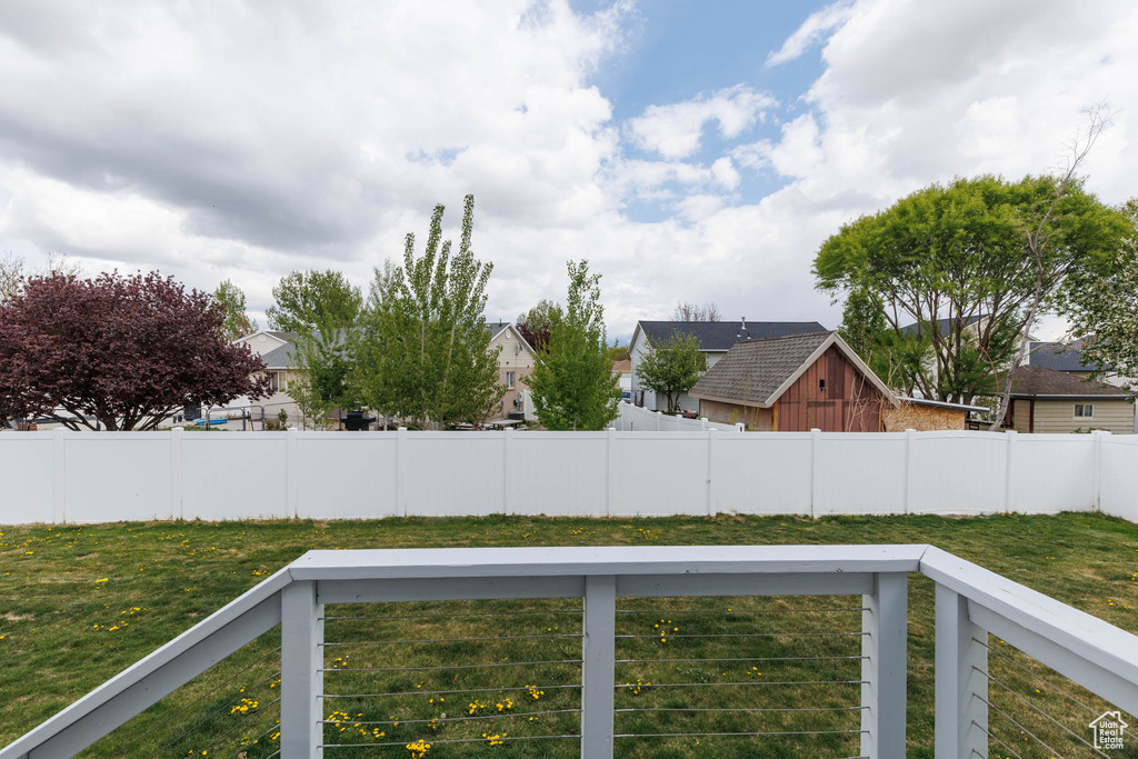 View of yard featuring fence, a residential view, and a wooden deck