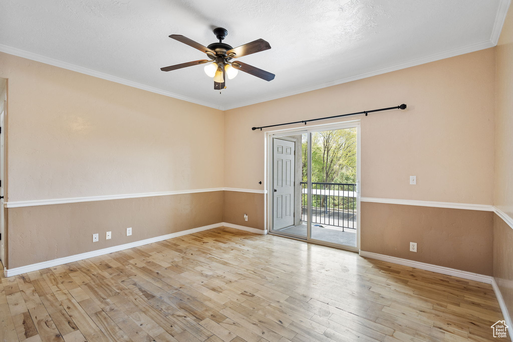 Unfurnished room with baseboards, crown molding, ceiling fan, and hardwood / wood-style floors