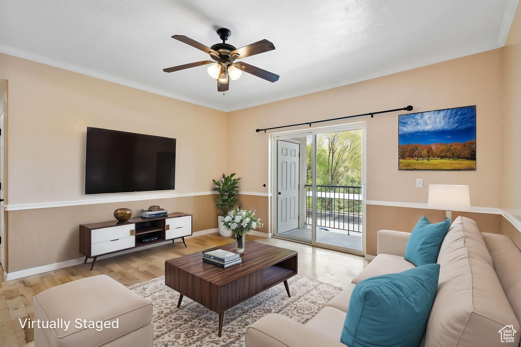 Living area with baseboards, ceiling fan, crown molding, and wood finished floors