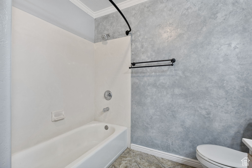 Full bath featuring tile patterned flooring, ornamental molding, tub / shower combination, toilet, and baseboards