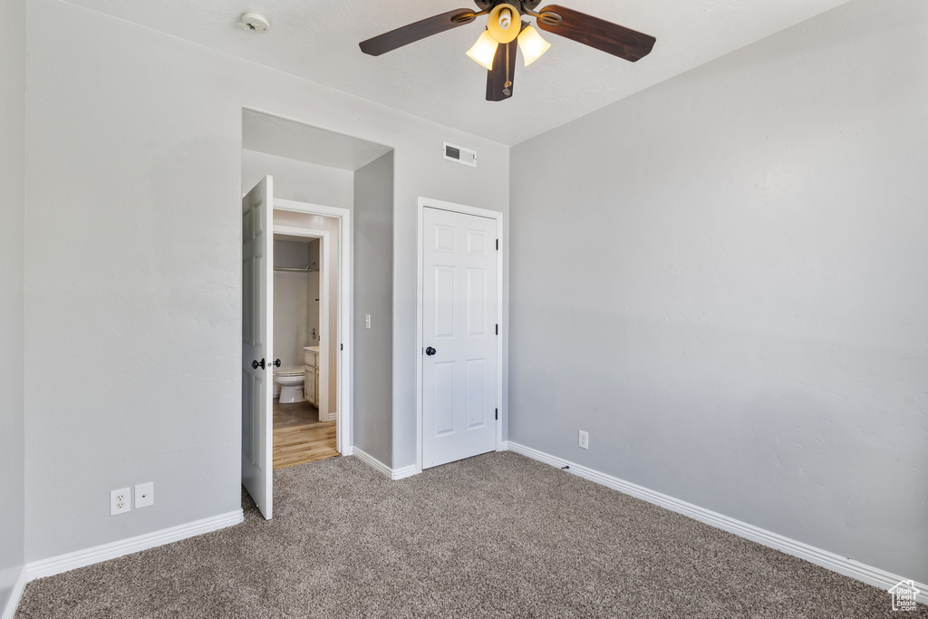 Unfurnished bedroom with visible vents, carpet flooring, baseboards, and ceiling fan