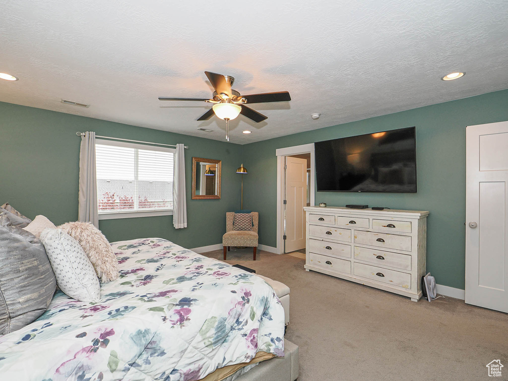 Bedroom featuring baseboards, light colored carpet, recessed lighting, and visible vents