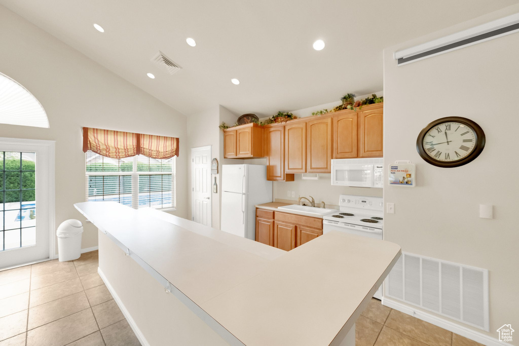 Kitchen featuring a sink, white appliances, light countertops, light tile patterned floors, and visible vents
