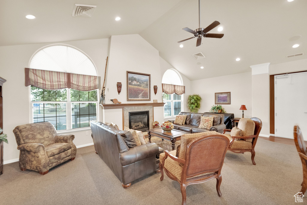 Carpeted living room with visible vents, a ceiling fan, recessed lighting, and a tile fireplace
