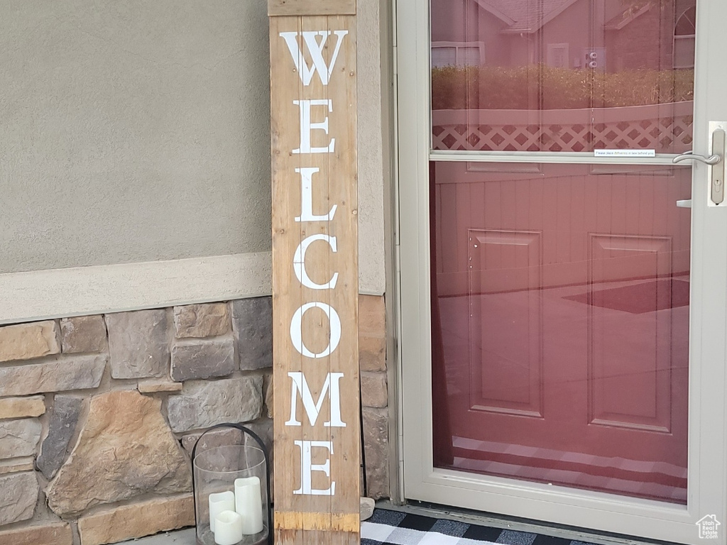 View of exterior entry with stucco siding