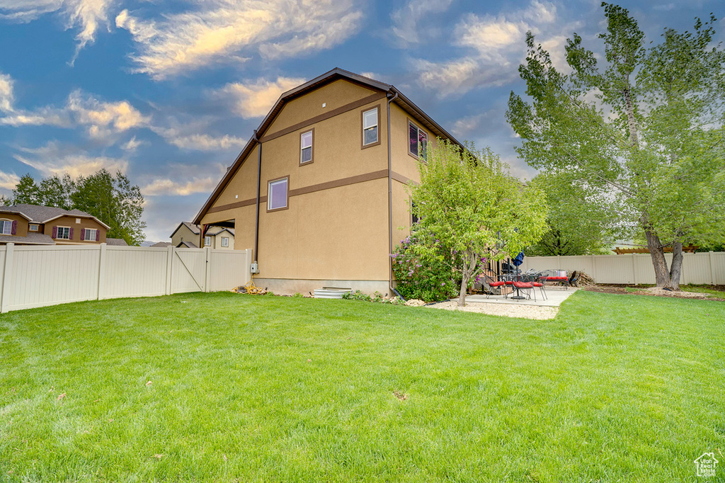 Exterior space with a fenced backyard and a patio area