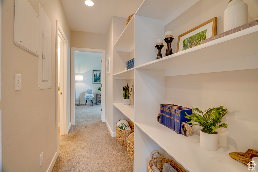 Hallway with baseboards, light carpet, and recessed lighting