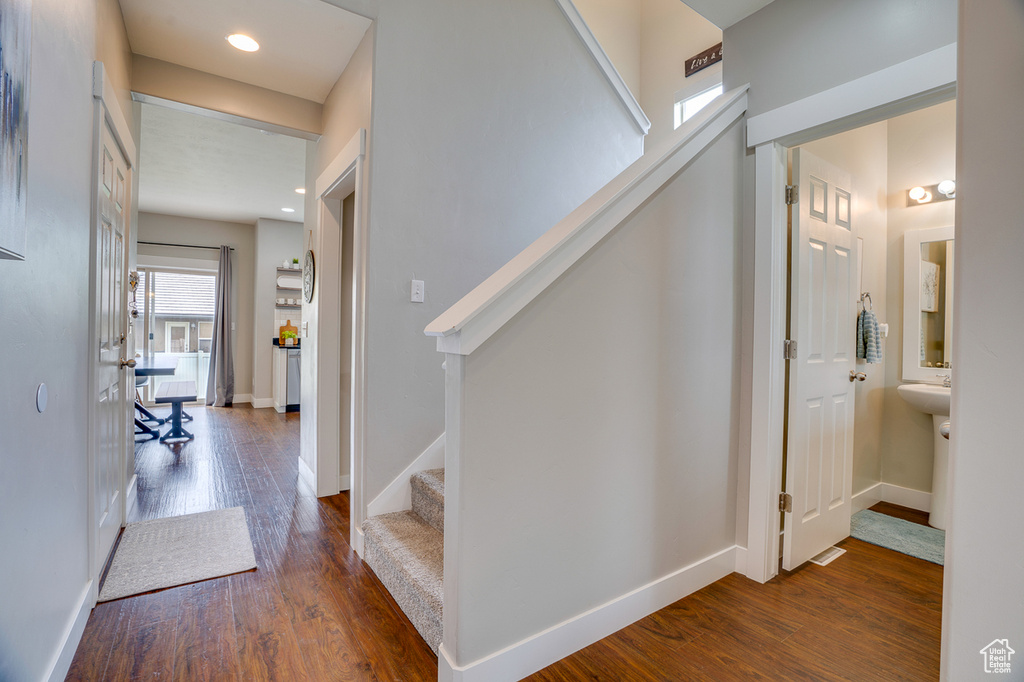 Interior space featuring baseboards, recessed lighting, wood finished floors, and stairway