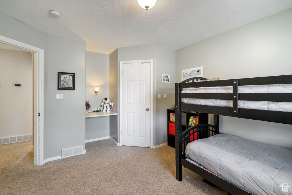 Bedroom with visible vents, baseboards, and carpet floors