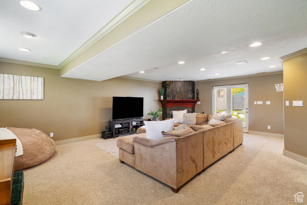 Living area with recessed lighting, ornamental molding, baseboards, and light carpet