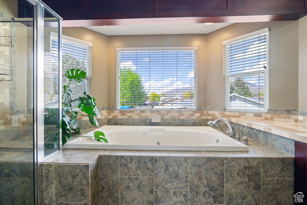 Bathroom featuring a garden tub and a stall shower