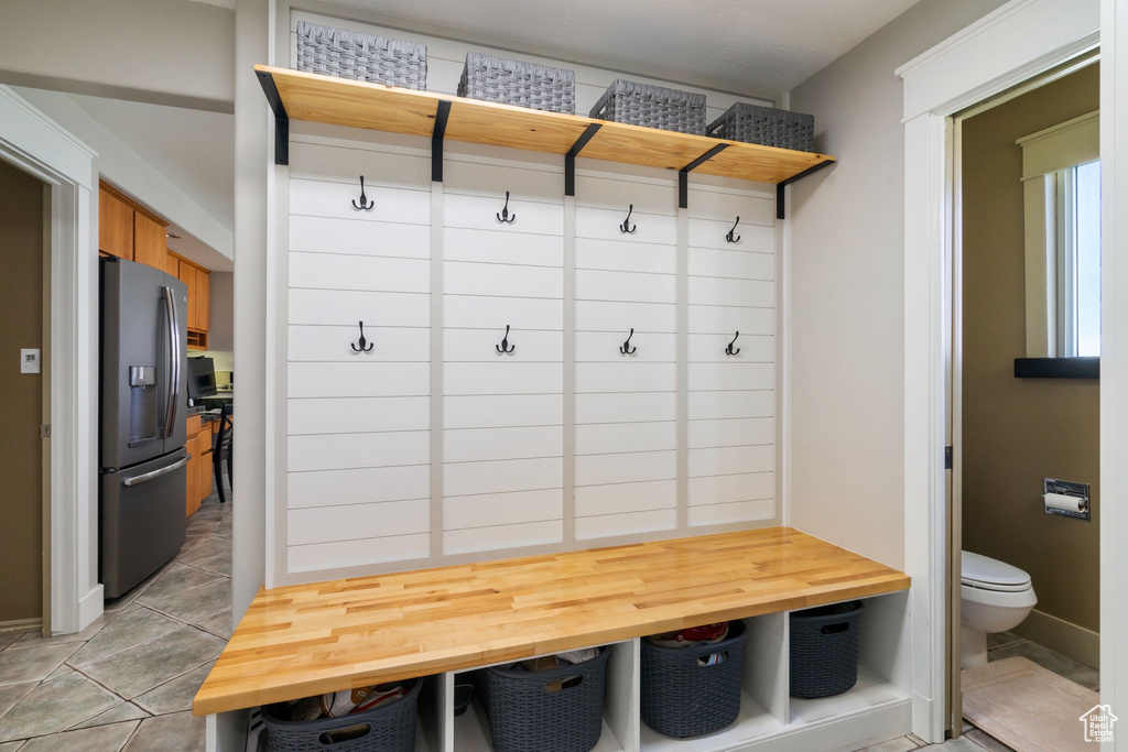 Mudroom with light tile patterned floors