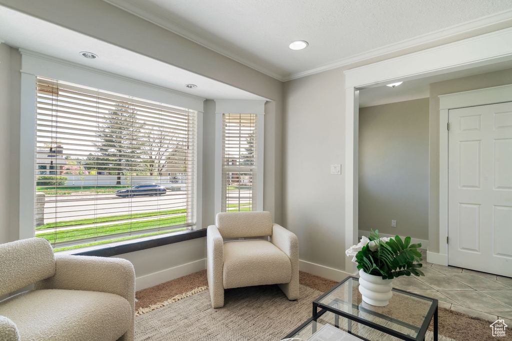 Sitting room with crown molding, recessed lighting, baseboards, and carpet