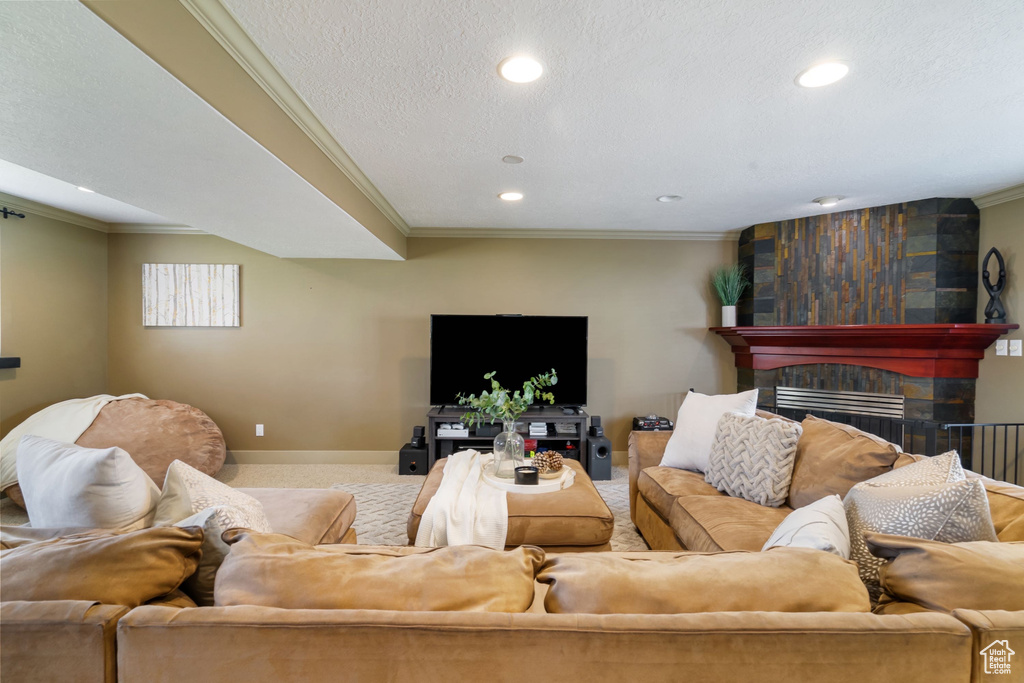 Living room with crown molding, recessed lighting, baseboards, and a large fireplace