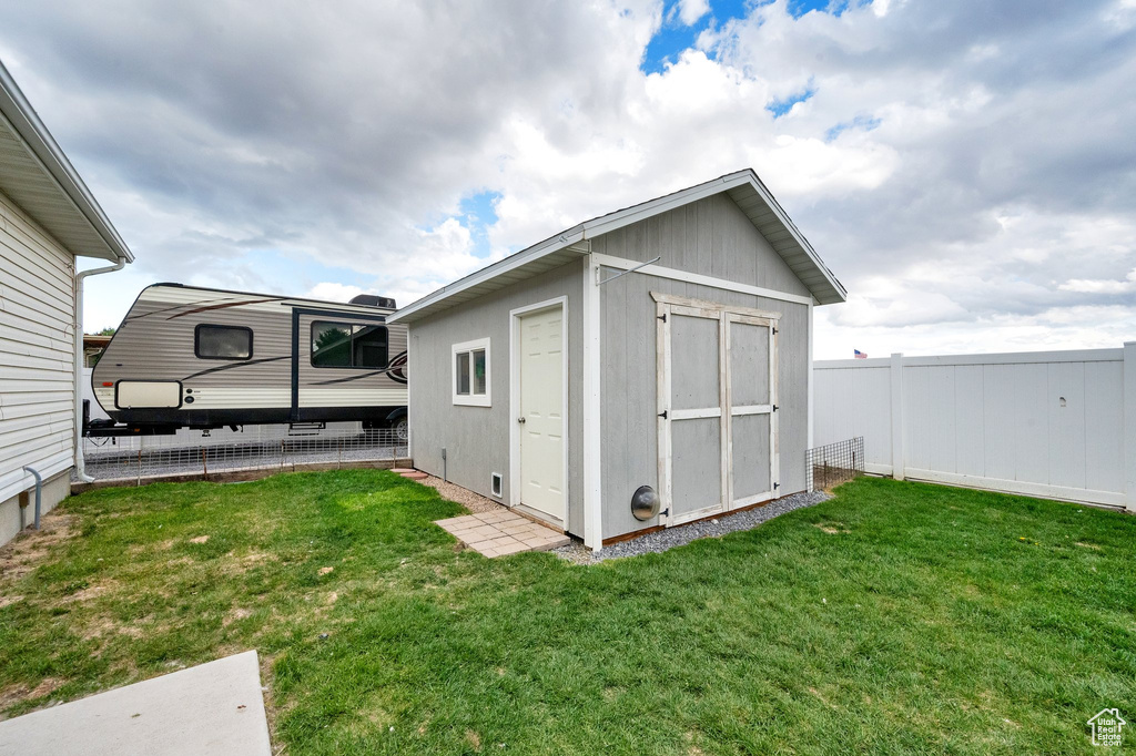 View of shed with a fenced backyard