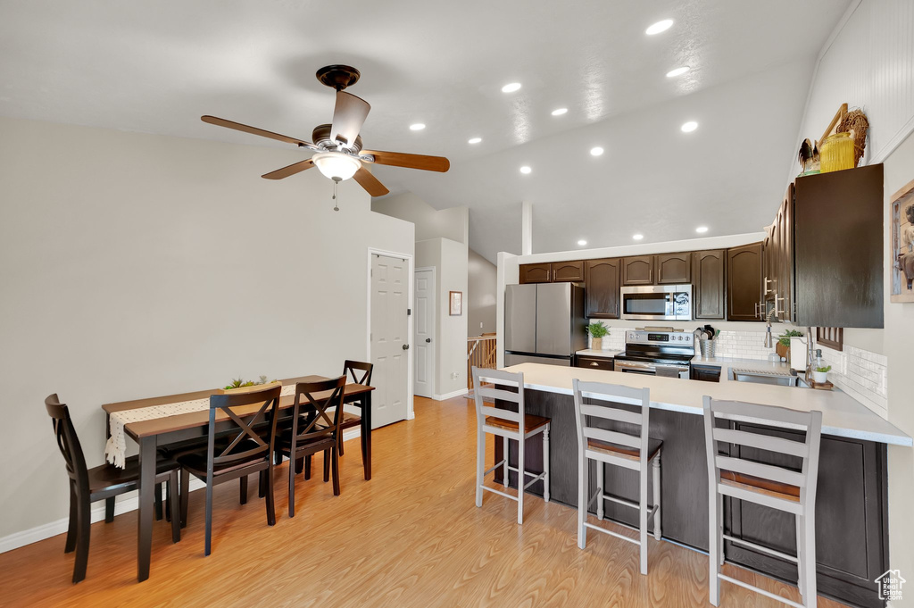 Kitchen featuring recessed lighting, a ceiling fan, stainless steel appliances, and a peninsula