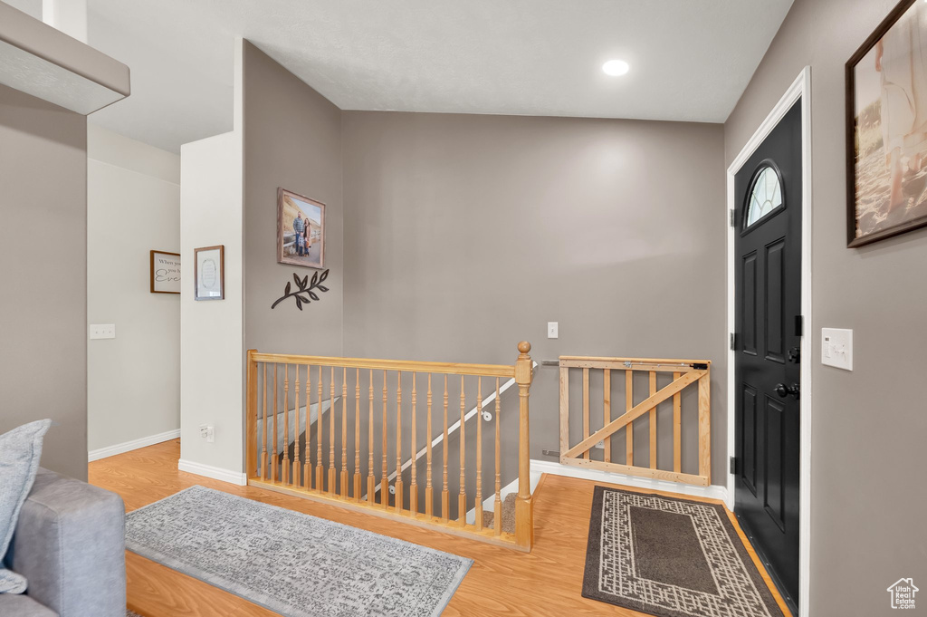 Foyer featuring baseboards, recessed lighting, and wood finished floors