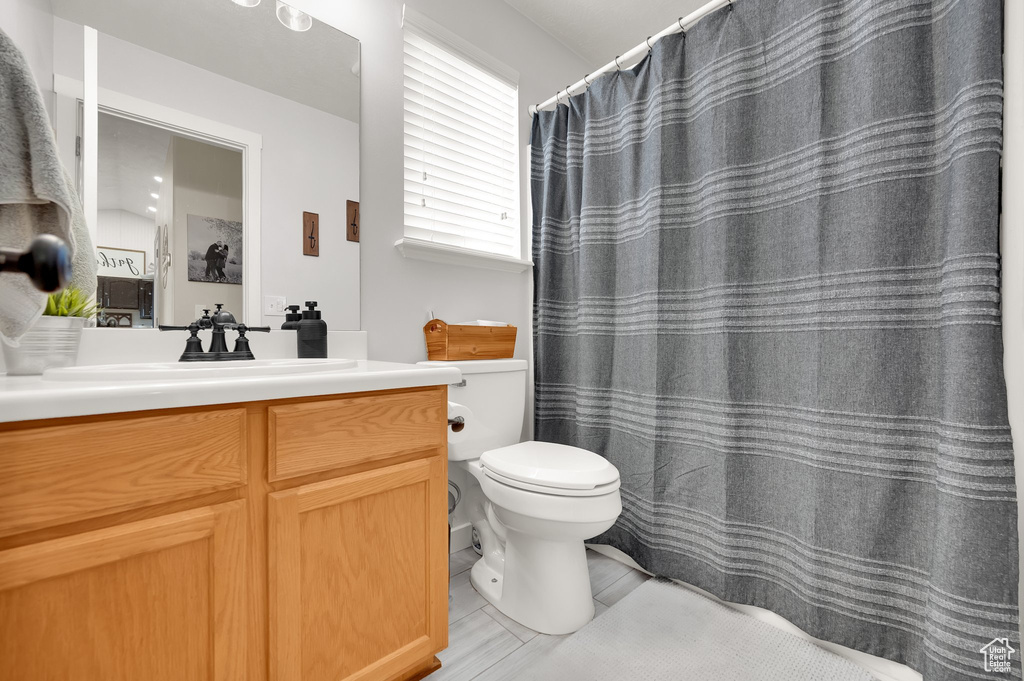 Bathroom with vanity, tile patterned floors, and toilet