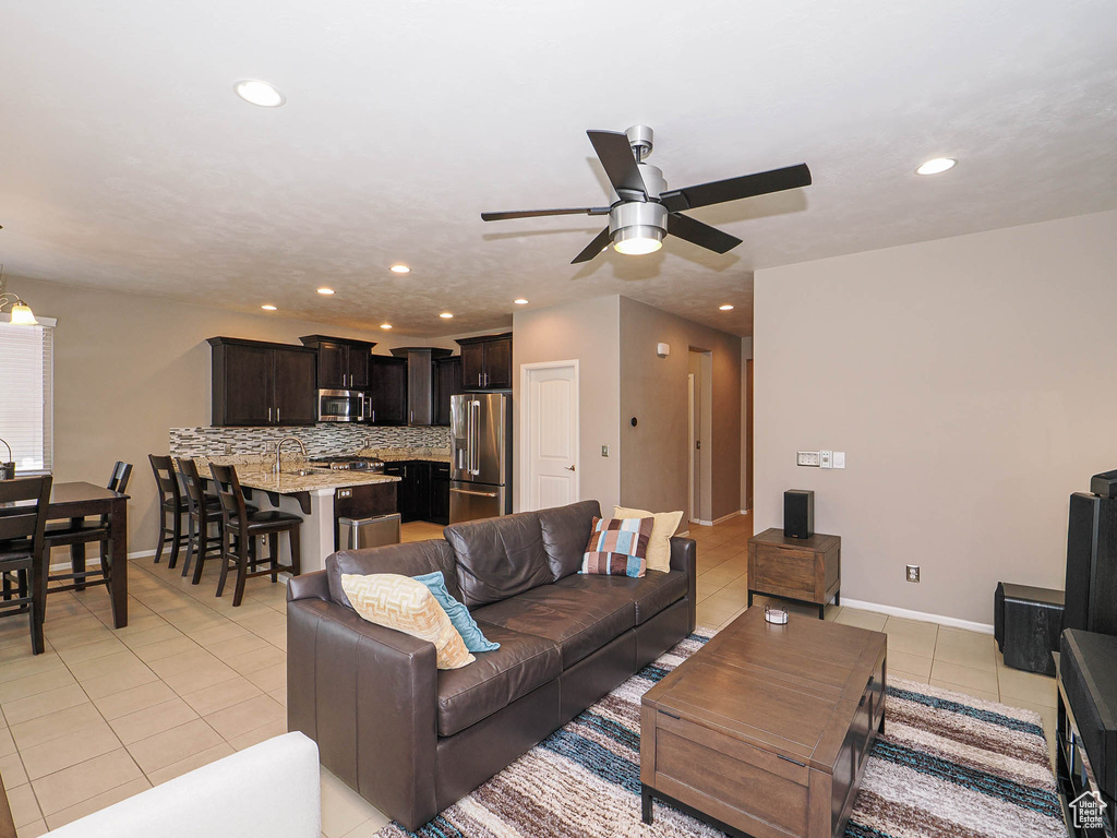 Living room with recessed lighting, a ceiling fan, baseboards, and light tile patterned flooring