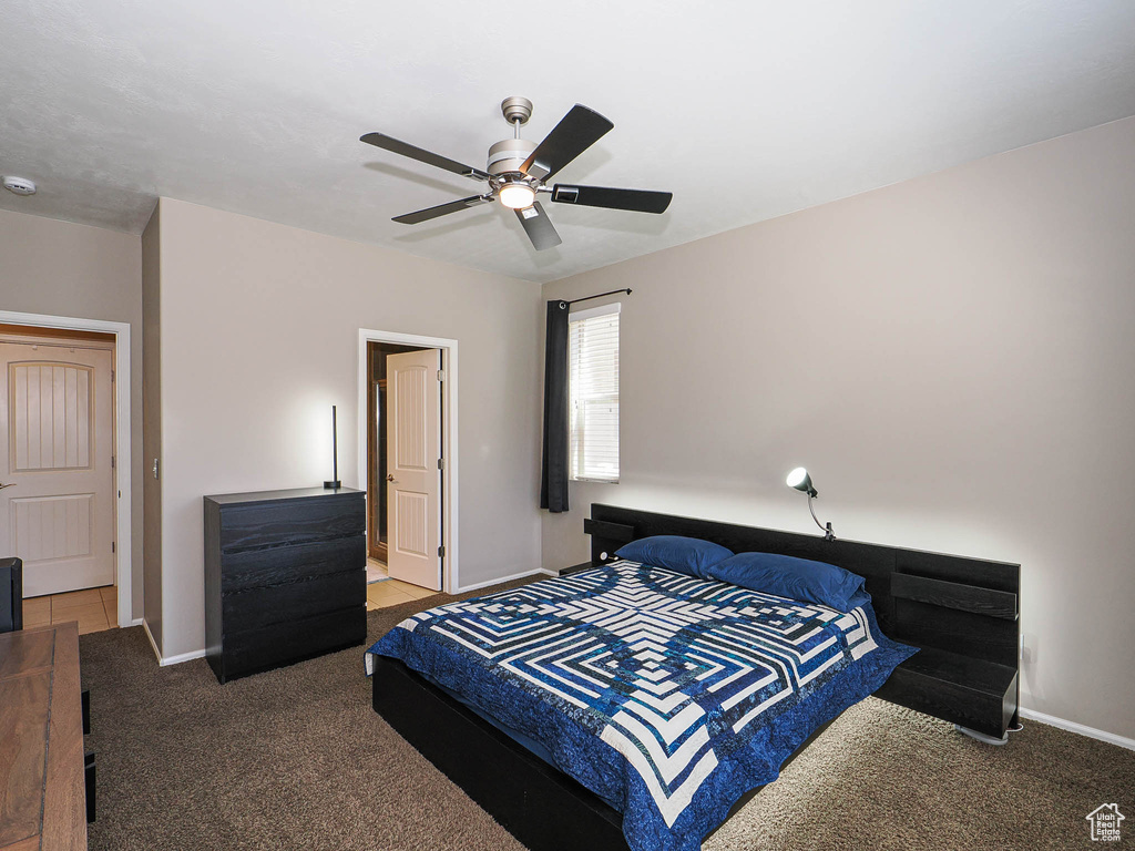 Bedroom featuring carpet flooring, baseboards, and ceiling fan