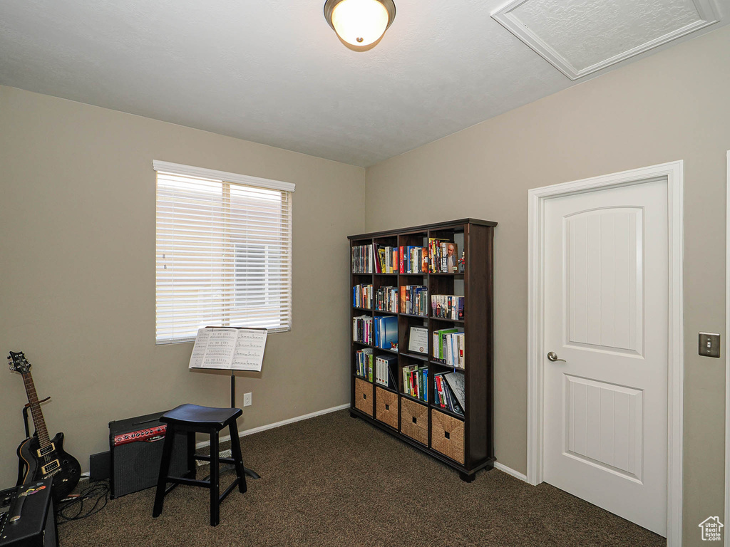 Office featuring dark colored carpet, attic access, baseboards, and visible vents