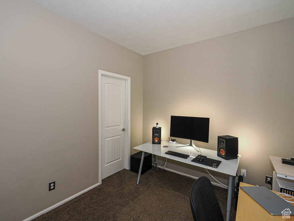 Home office with baseboards and carpet flooring