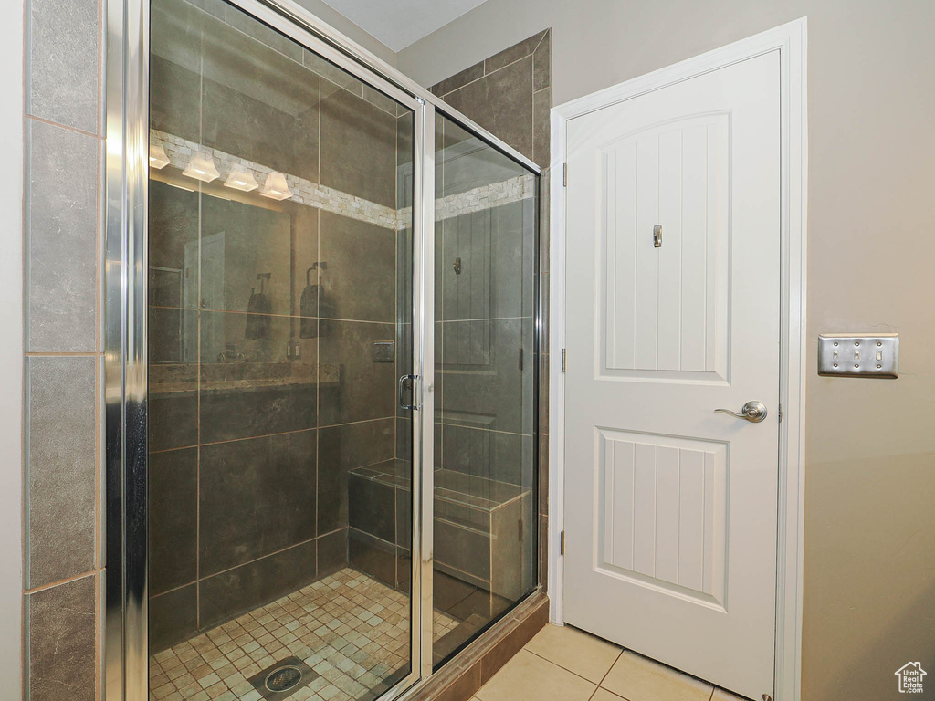 Full bathroom with a shower stall and tile patterned flooring