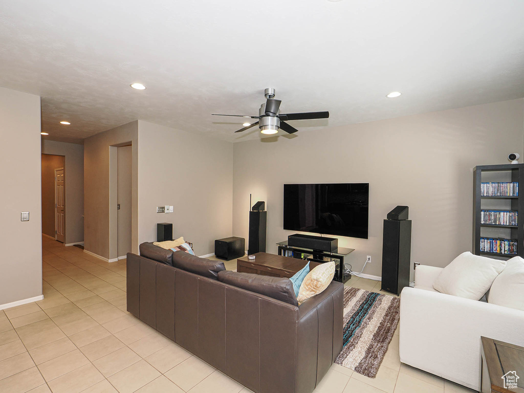 Living area with light tile patterned flooring, a ceiling fan, recessed lighting, and baseboards