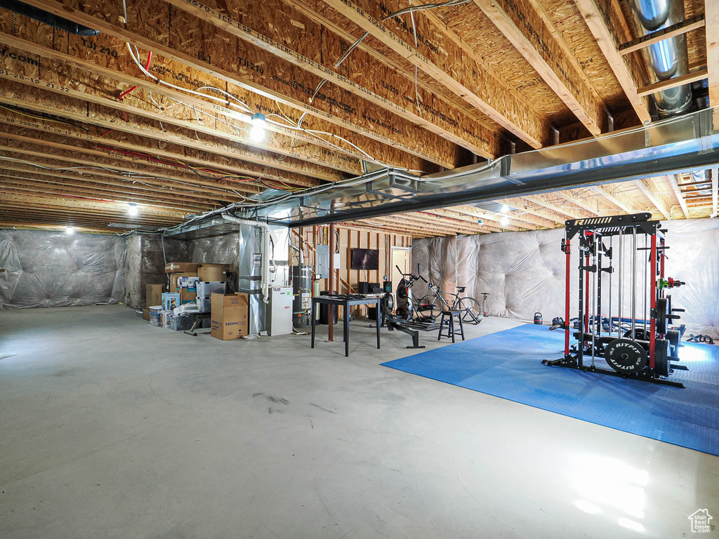 Unfinished below grade area featuring gas water heater