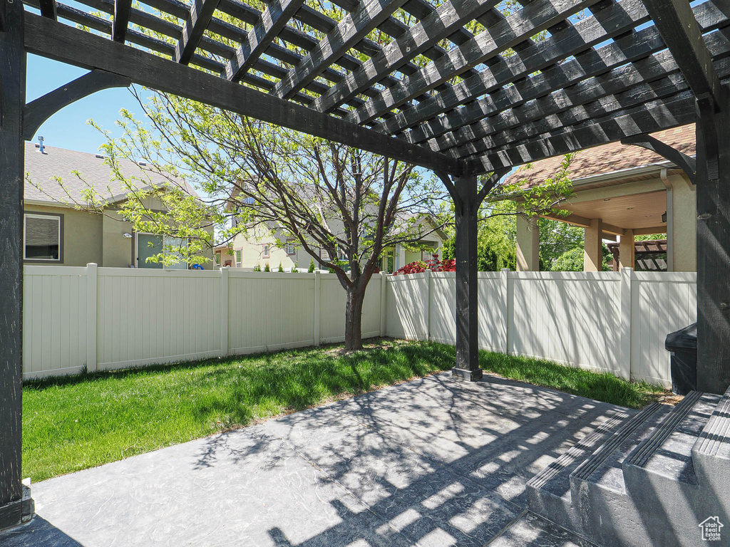 View of patio with fence and a pergola