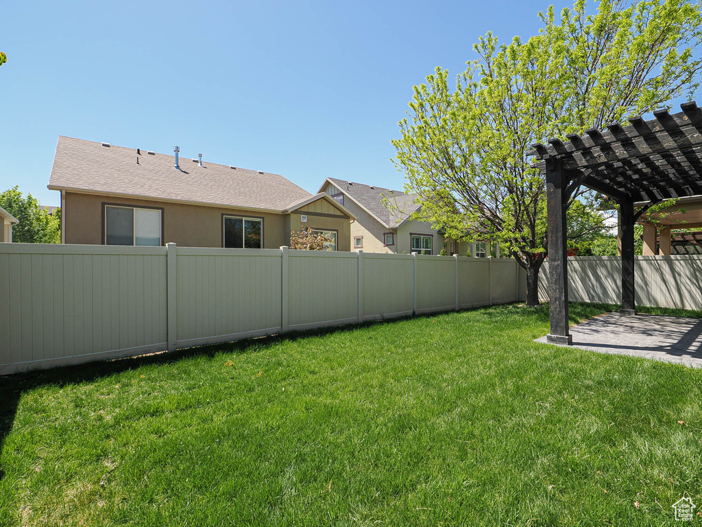 View of yard with a fenced backyard, a patio area, and a pergola