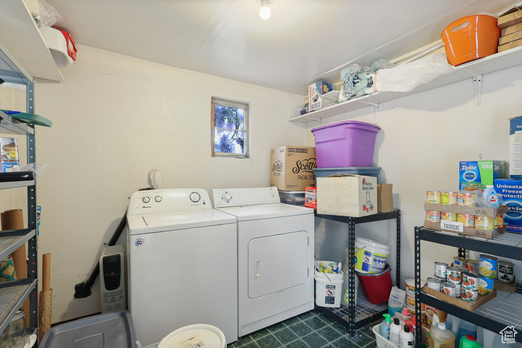 Laundry area with independent washer and dryer, laundry area, and dark tile patterned flooring