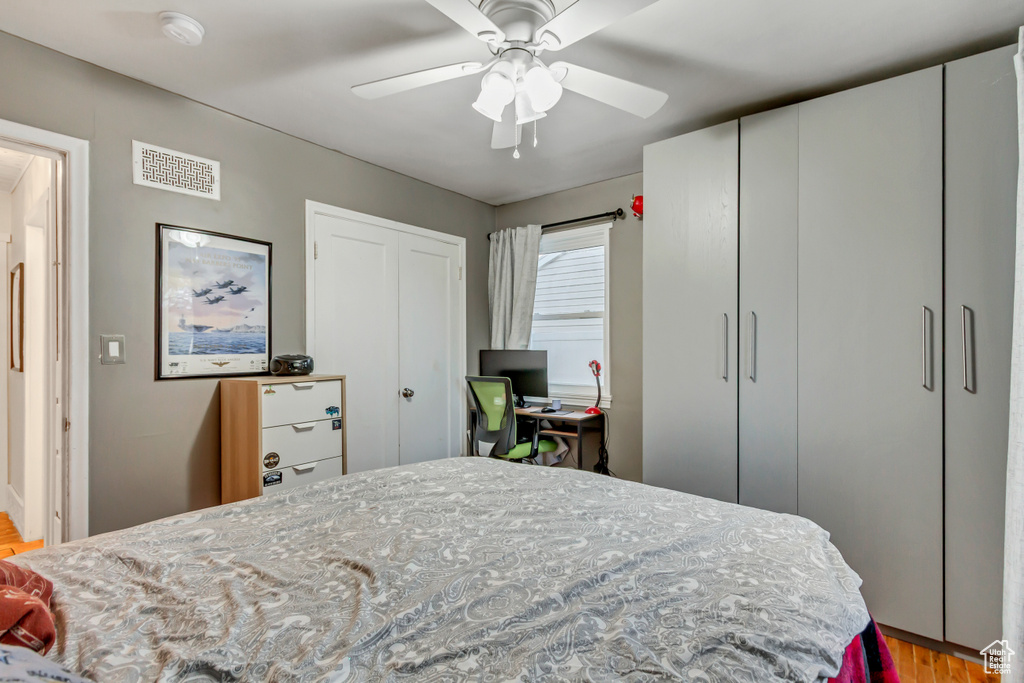 Bedroom featuring a ceiling fan, light wood-type flooring, and visible vents