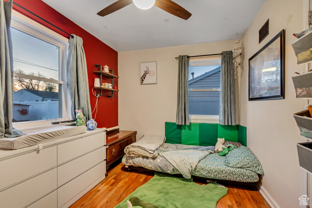 Bedroom with ceiling fan, visible vents, and light wood-style floors