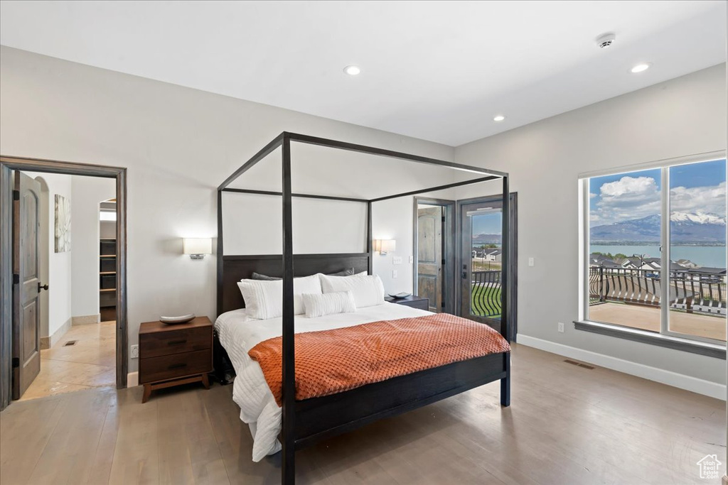 Bedroom with visible vents, light wood-type flooring, baseboards, access to outside, and recessed lighting