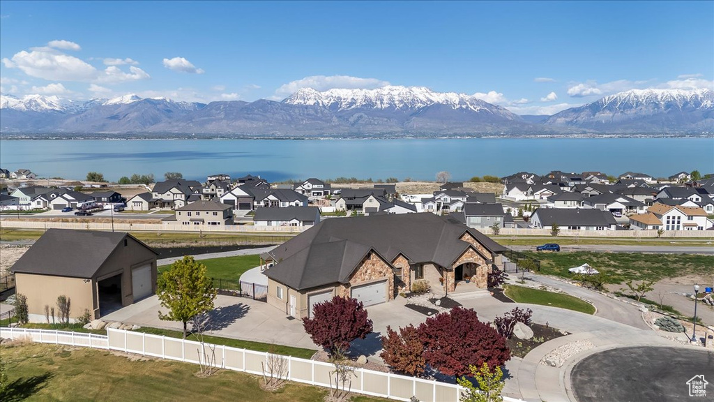 Birds eye view of property with a water and mountain view and a residential view