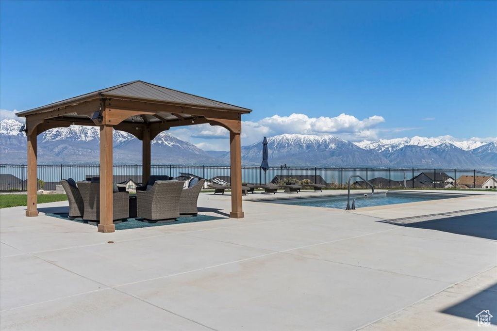 View of pool featuring a gazebo, a mountain view, fence, and a fenced in pool