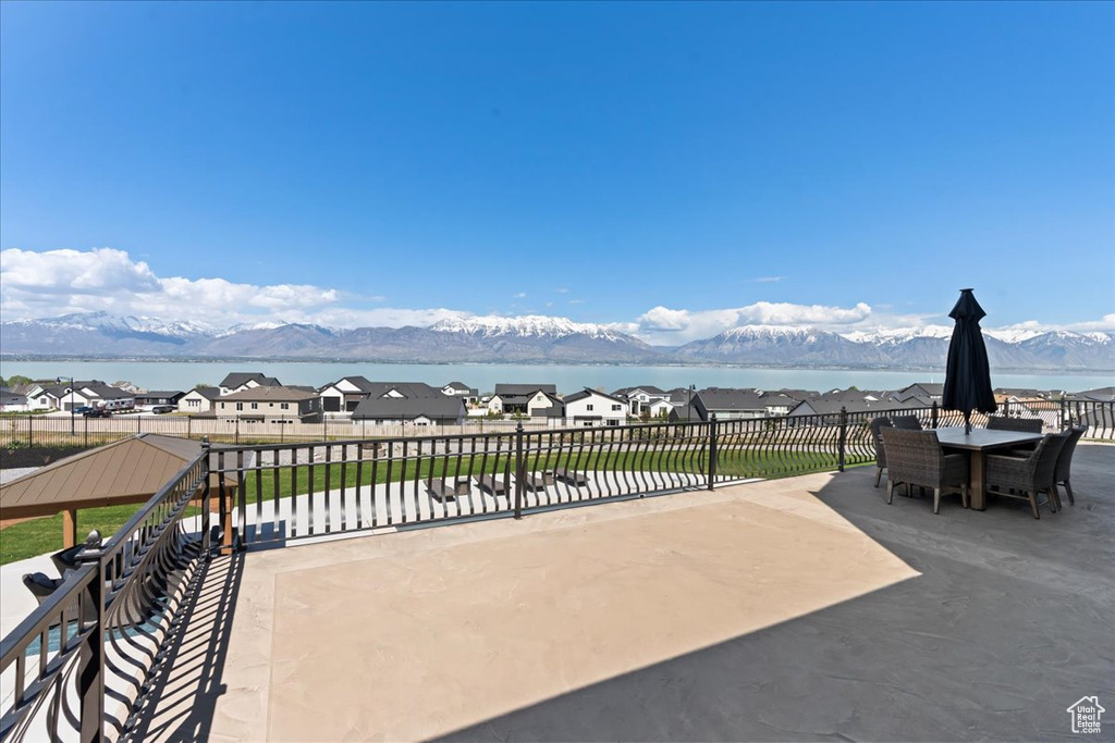 View of patio / terrace featuring a water and mountain view
