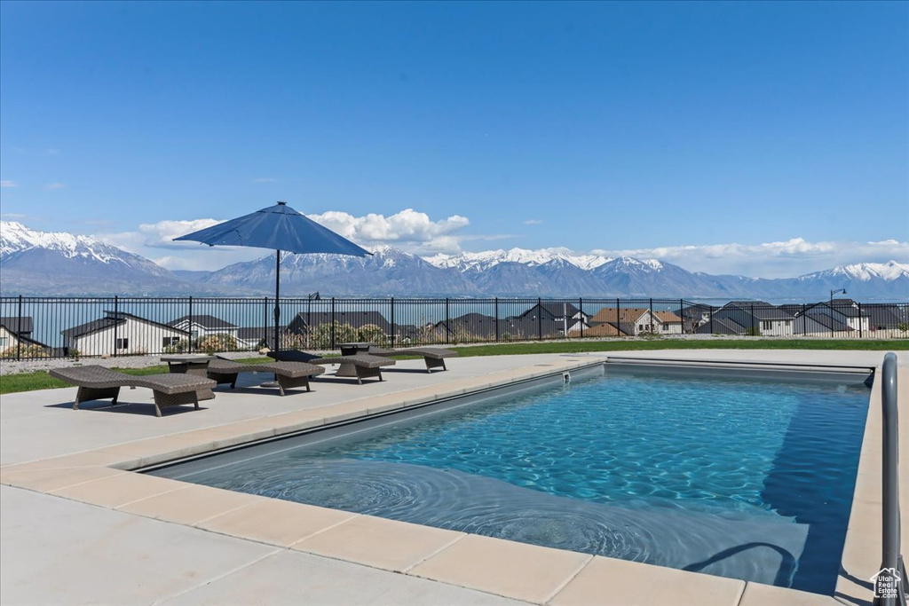 View of pool featuring a patio, fence, a mountain view, and a fenced in pool