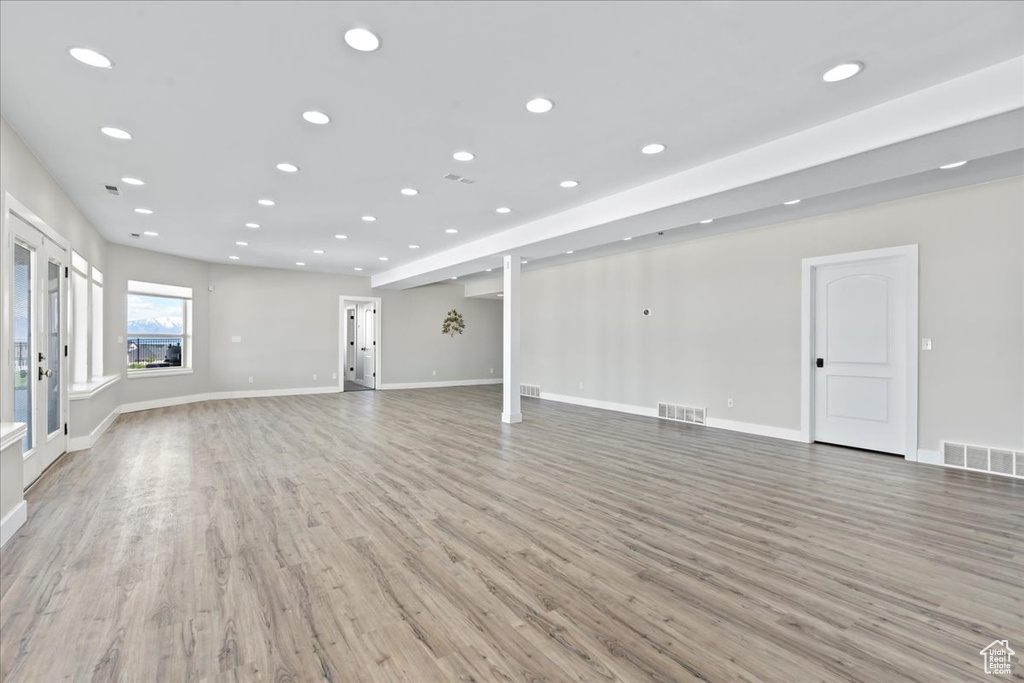 Unfurnished living room featuring recessed lighting, visible vents, and light wood finished floors