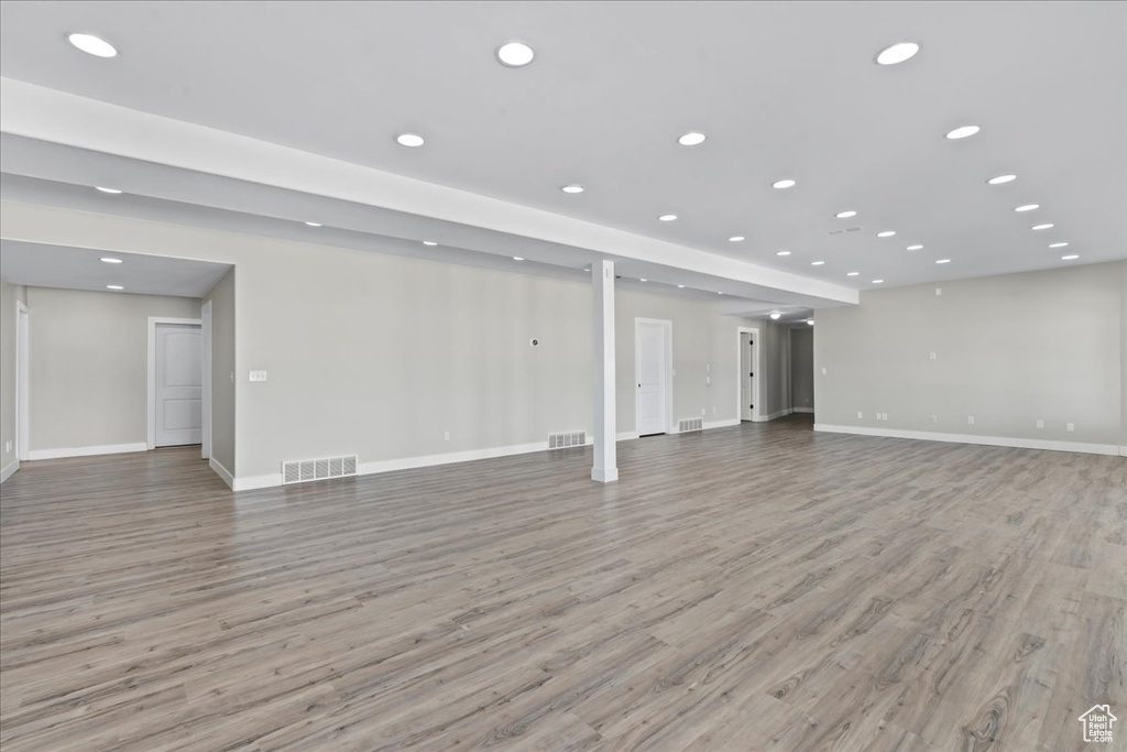 Below grade area featuring visible vents, recessed lighting, baseboards, and light wood-type flooring
