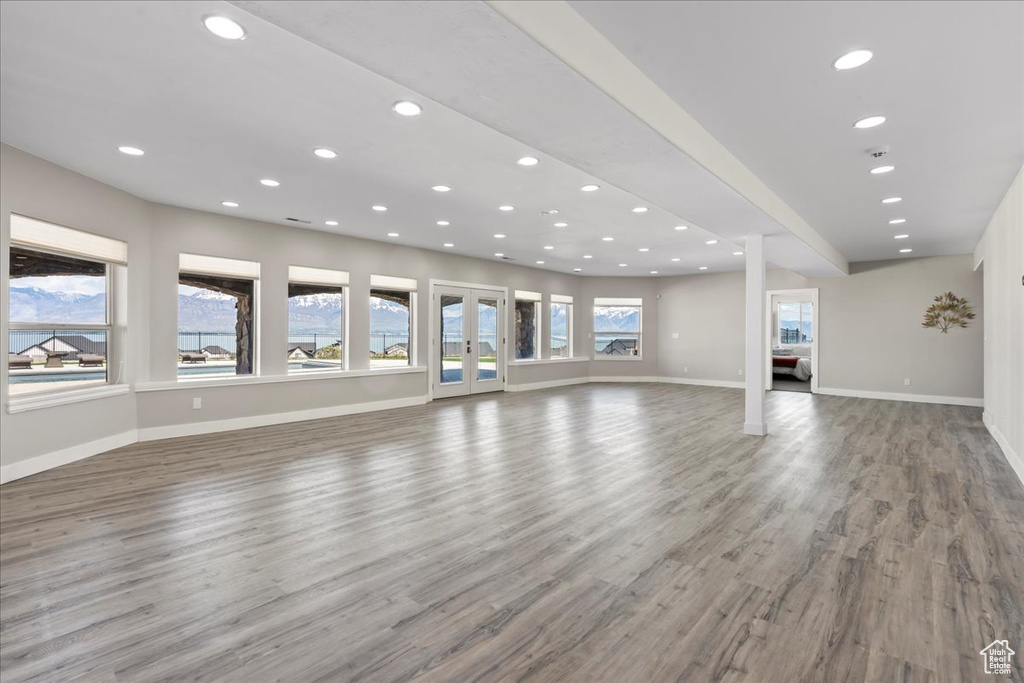 Unfurnished living room featuring recessed lighting, baseboards, and wood finished floors