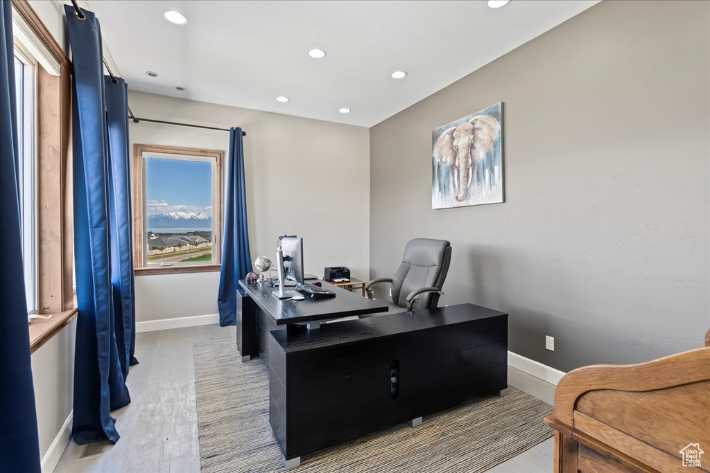 Home office with light wood-style floors, baseboards, and recessed lighting