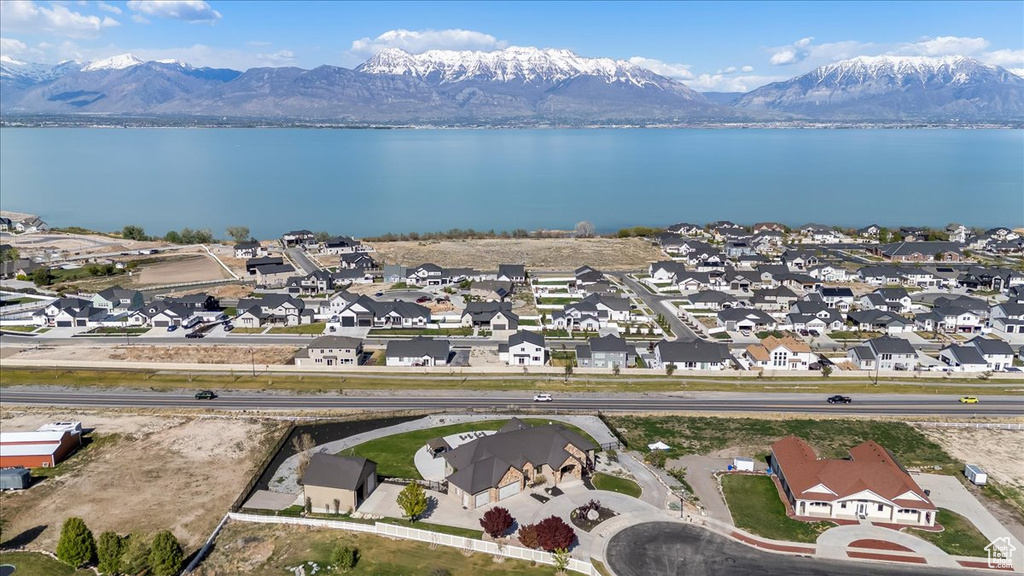Birds eye view of property with a residential view and a water and mountain view