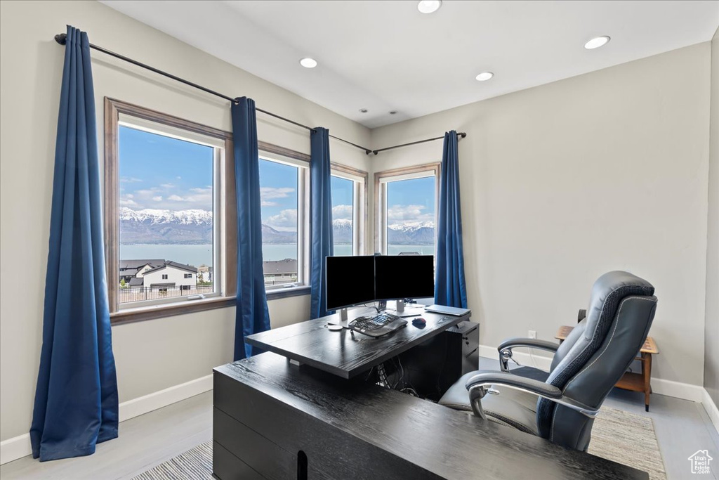 Office space with baseboards, recessed lighting, and light wood-style floors