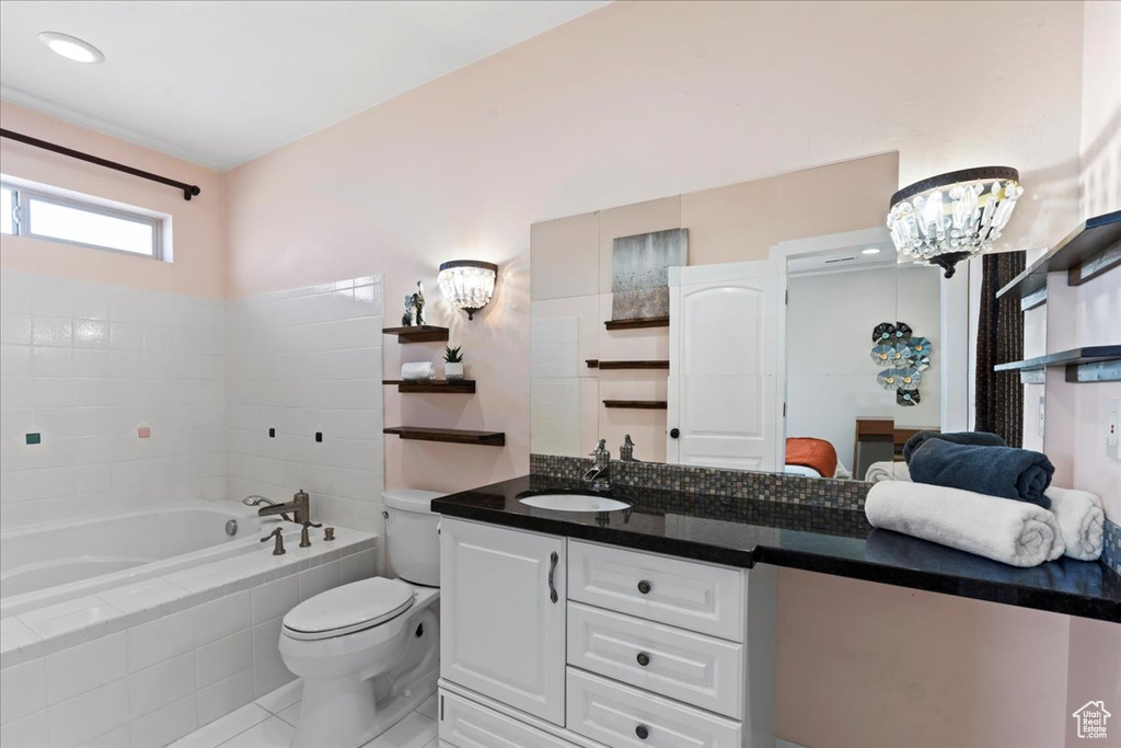 Ensuite bathroom with a bath, vanity, tile patterned floors, toilet, and ensuite bath