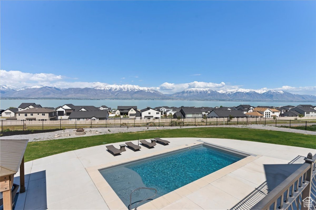 View of swimming pool with a fenced backyard, a fenced in pool, a yard, and a patio area