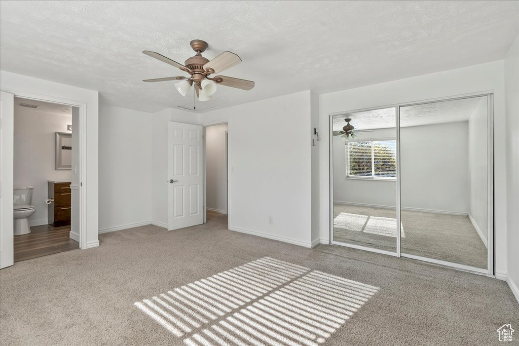 Unfurnished bedroom with baseboards, carpet, and a closet