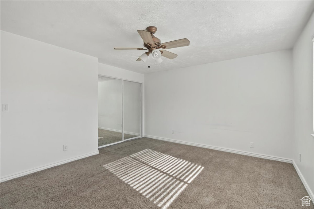 Unfurnished bedroom featuring a closet, carpet, and baseboards